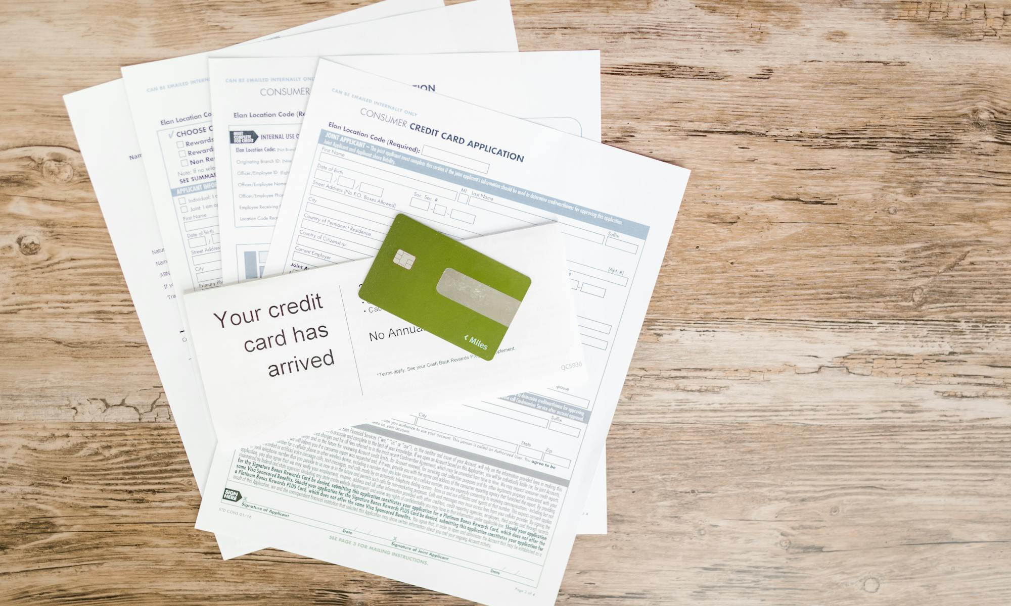 Credit card and bills on a desk before a hardship call